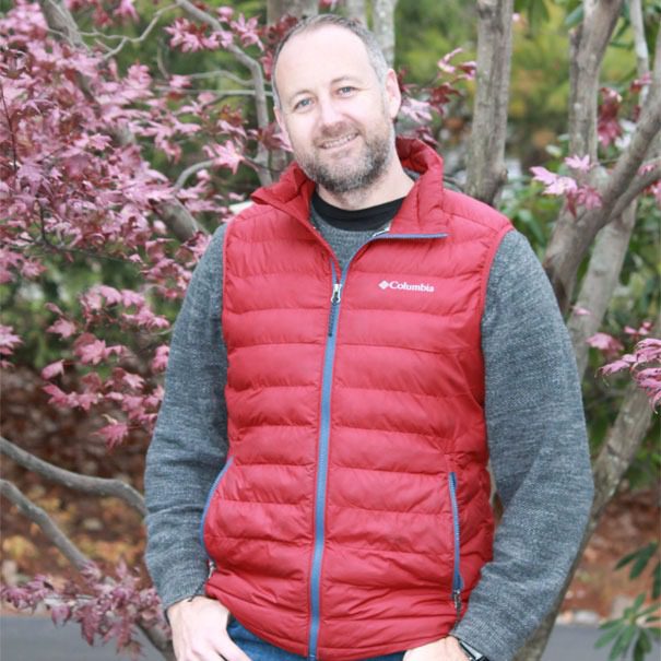 Man in red vest among autumn leaves