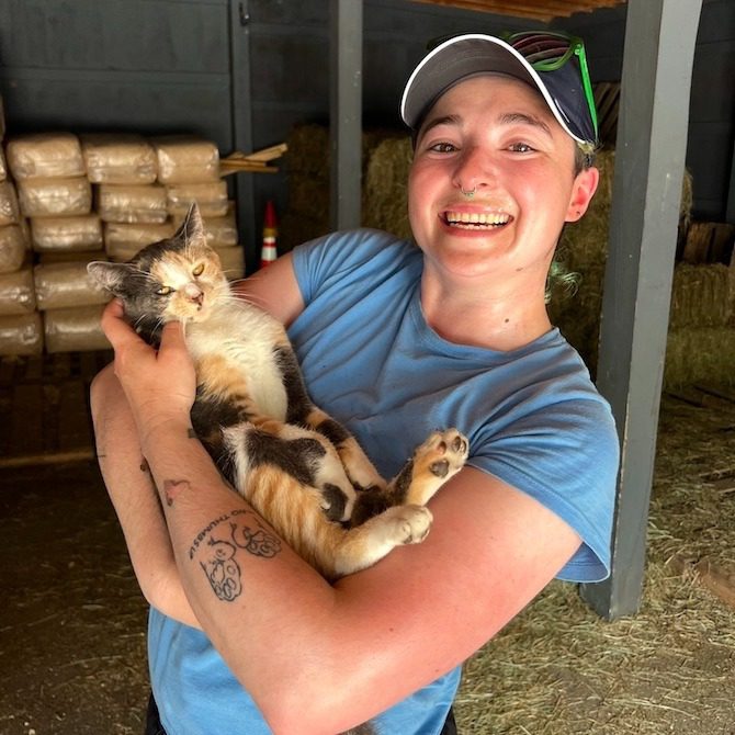 Happy moment with a cat in barn