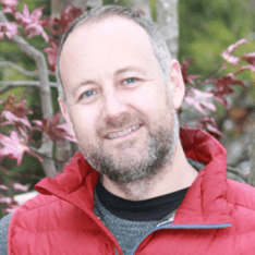 Man with beard and red vest